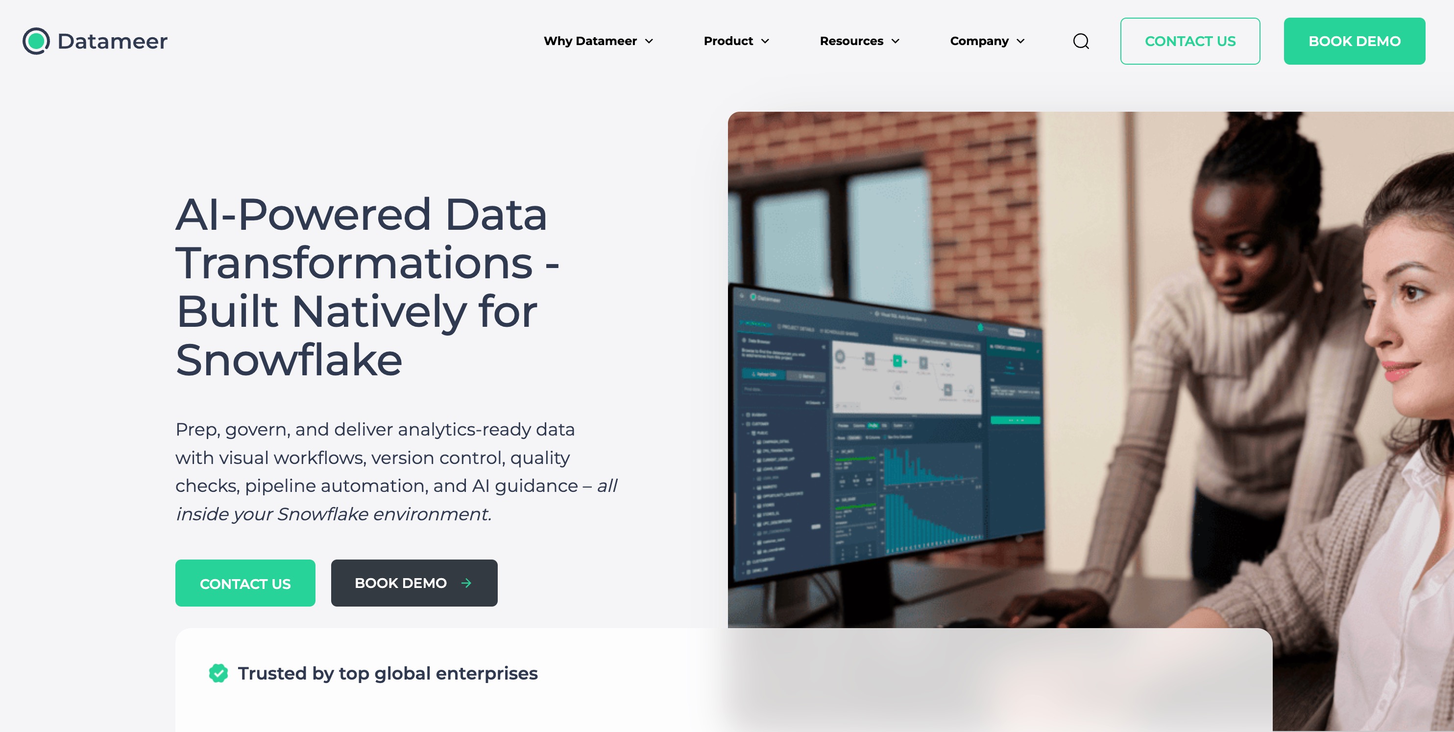 Datameer home page headlined AI-Powered Data Transformations built natively for Snowflake, beside a photograph of two colleagues reviewing a Datameer pipeline on a monitor